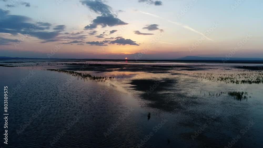 Beautiful sunset or sunrise in wetland vast desert with migratory water birds. High resolution and quality aerial footage. Beautiful sunset or sunrise in wetland vast desert with migratory water birds. High resolution and quality aerial footage.