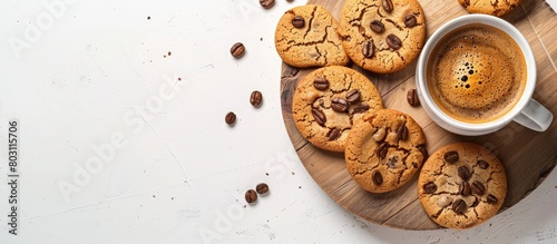 Espresso coffee and cookies arranged on a wooden cutting board against a white backdrop with room for text. photo