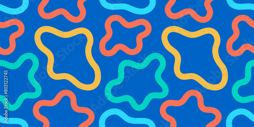 Abstract vibrant blob shapes seamless pattern. Colorful trendy doodle cow spots animal skin design on a blue background.