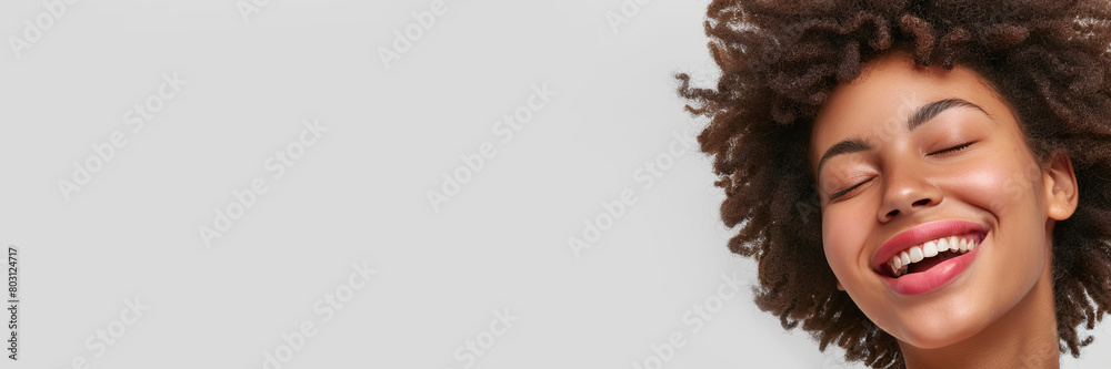 Banner portrait of serene girl with eyes closed and smile isolated on white studio backdrop. Happy attractive sensual young woman with afro hairstyle, perfect skin, day makeup. Delight, enjoyment. Banner portrait of serene girl with eyes closed and smile isolated on white studio backdrop. Happy attractive sensual young woman with afro hairstyle, perfect skin, day makeup. Delight, enjoyment.
