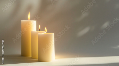 Glowing candles on white background