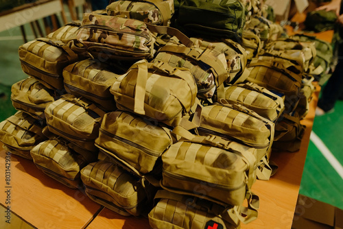 A group of military first aid kits on a table. Tactical first aid kits for the military