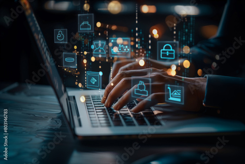 a person's hands typing on a laptop with holographic cybersecurity icons floating above the keyboard, illustrating advanced digital security and data protection technologies in a dark setting. © Skip Monday