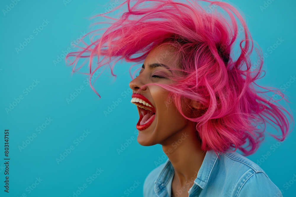 Happy Indian woman laughing joyously, pink hair tossed by the wind