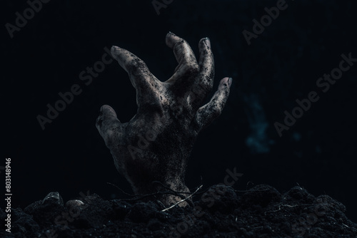 Scary zombie hand on a dark background. Horror Halloween concept. photo