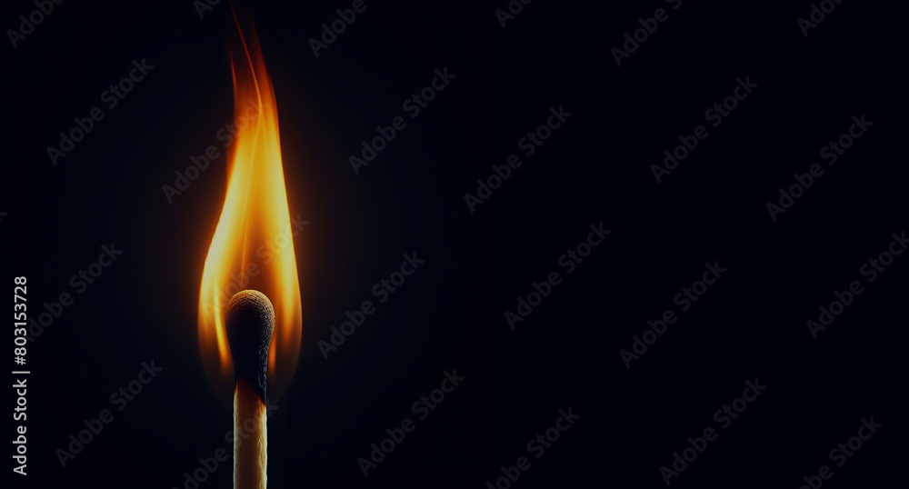 burning match stick on black background
