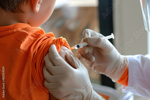 Child receiving a vaccination. Little boy in face mask in doctor's office is vaccinated. Kid giving injection shot. Syringe with covid-19, coronavirus, flu vaccine. Dangerous infectious disease, MPOX