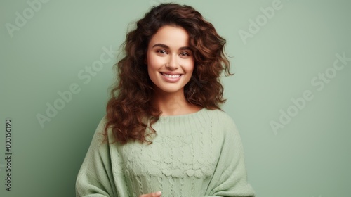 Radiant Young Woman with Curly Hair Smiling on Green Background