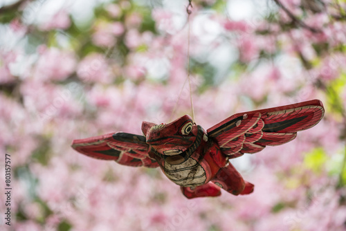 Red frog with wings with blur pink sakura at Nyoirinji temple, Ogori