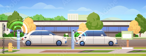 Electric vehicles are charged at charging stations. Green energy outdoor composition