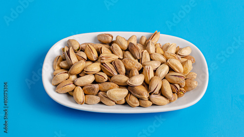 Pistachios bowl isolated on blue