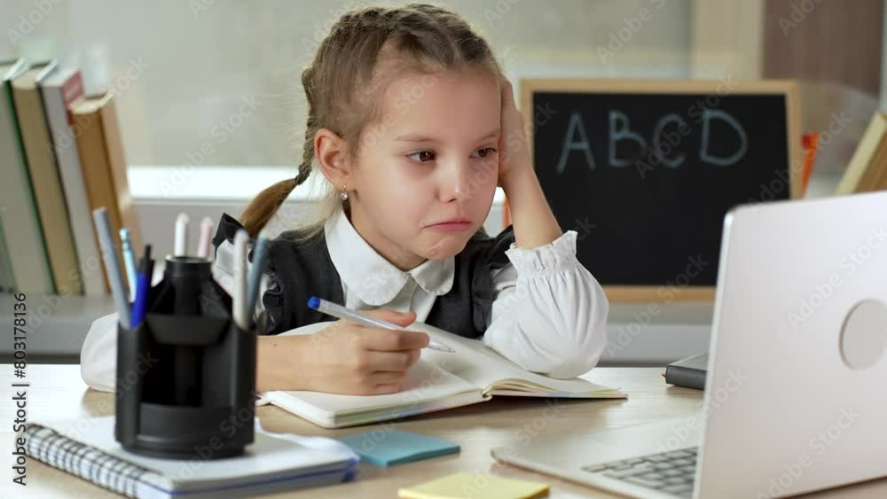 Sad girl reading boring or lazy doing homework. Worried and stressed school girl crying Sad girl reading boring or lazy doing homework. Worried and stressed school girl crying
