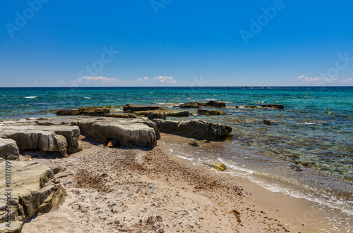 Fototapeta Naklejka Na Ścianę i Meble -  reefs and crystal clear water of Aegean Sea on Gilikli beach near Alacati (Cesme, Izmir province, Turkey)	