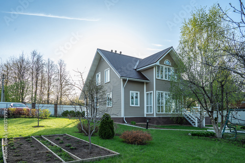 Russian dacha with cottage, garden, vegetable garden, lawn and footpaths.