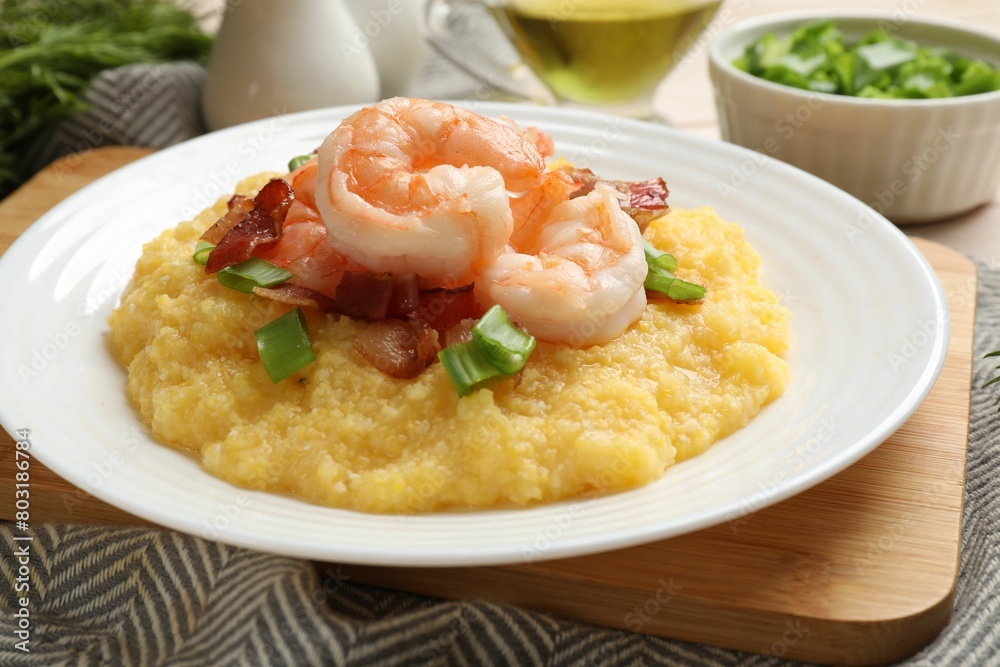 Plate with fresh tasty shrimps, bacon, grits and green onion on table, closeup Plate with fresh tasty shrimps, bacon, grits and green onion on table, closeup