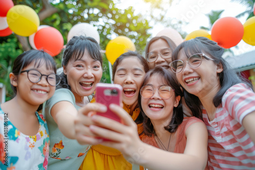 A snapshot of cousins taking a selfie together amidst a cheerful family reunion at a garden barbecue party, highlighting the joy and togetherness of the occasion.