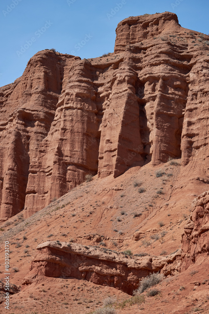 Rocky columns of red sandstone in Konorchek canyon, aeolian deposits