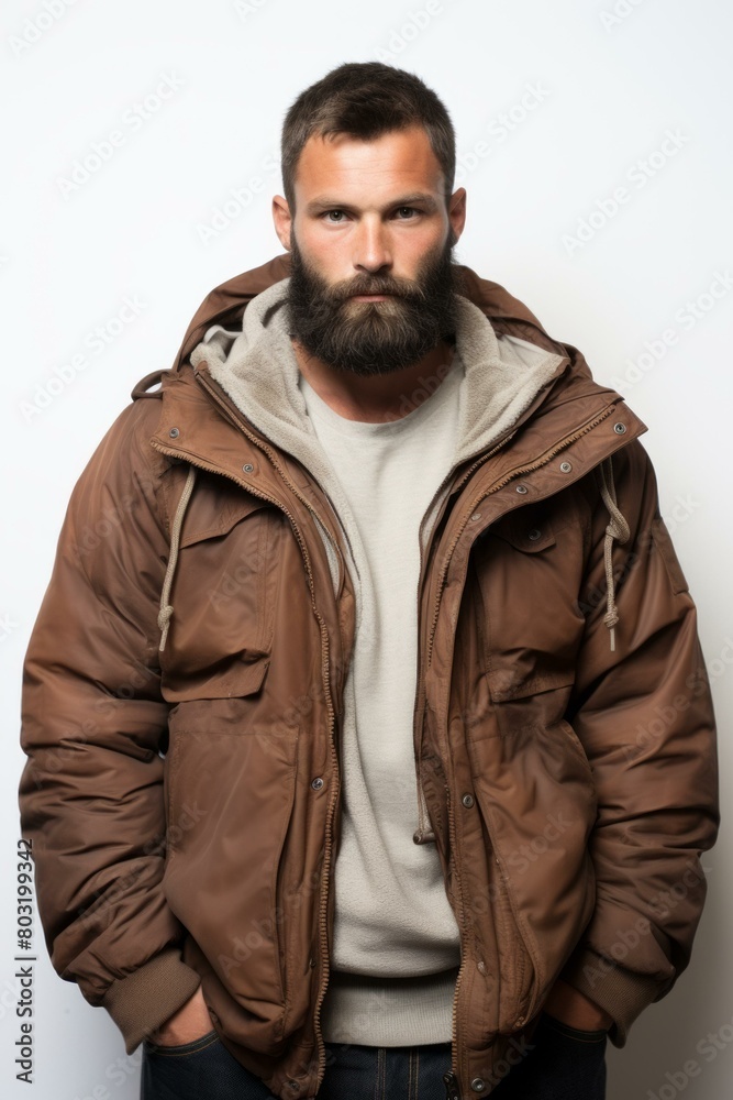 portrait of a handsome bearded man in a brown jacket portrait of a handsome bearded man in a brown jacket