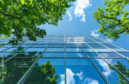 A modern office building with green trees in front of it
