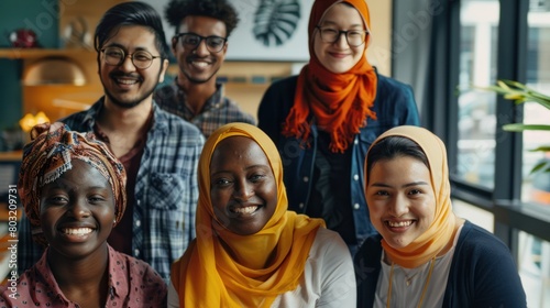A diverse group of coworkers of various nationalities and faiths, smiling and collaborating in a modern office space, promoting inclusivity and cooperation photo