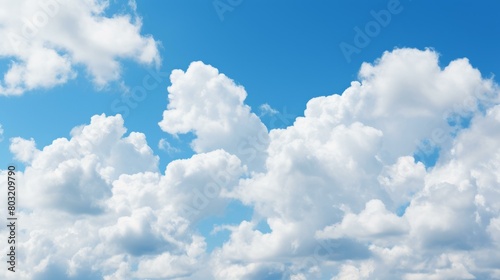 White Puffy Clouds Dotted Across Vibrant Blue Sky