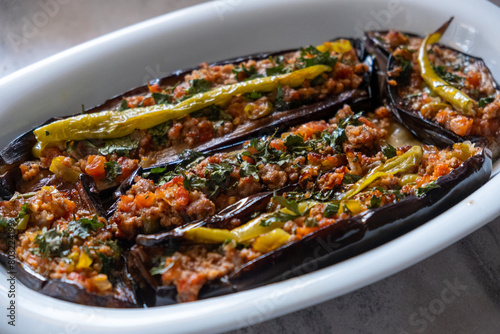Karniyarık with minced meat and eggplant, a Turkish traditional dish, on a oval serving plate photo