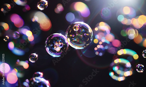 iridescent bubbles agains a black smooth backround