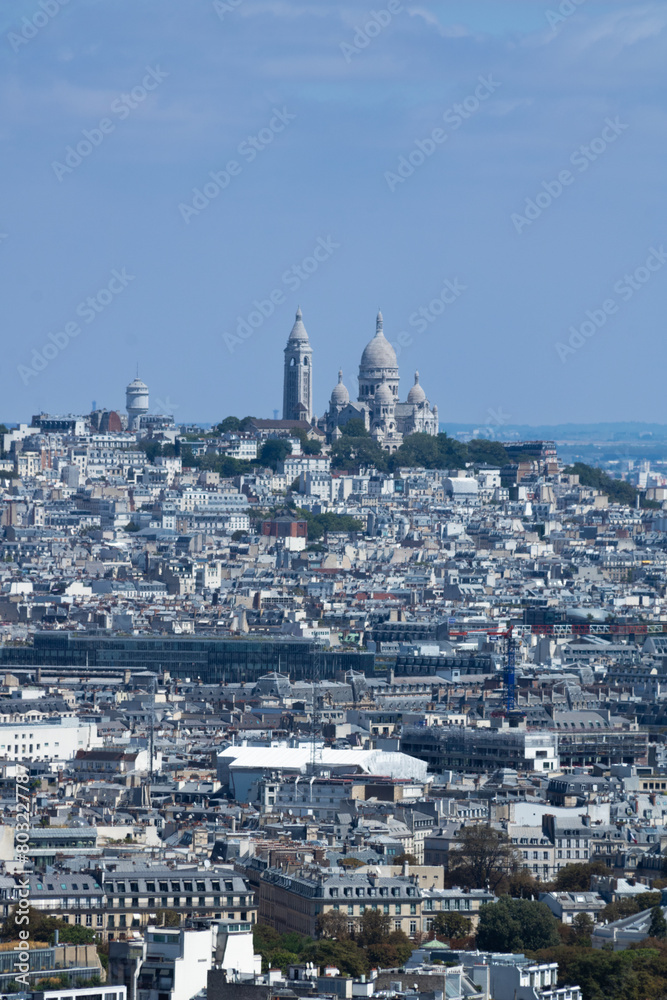 Sacré-Cœur is a basilica on top of Montmartre hill (Paris, France). Panoramic view of the roofs of the buildings around the Tour Eiffel, Paris, France