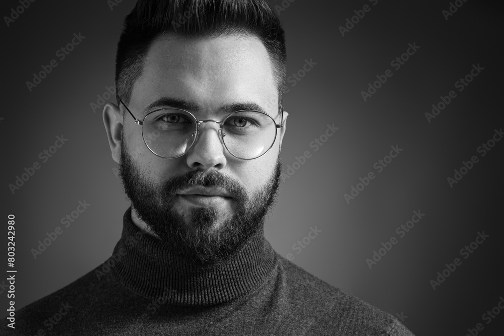 Portrait of handsome bearded man on dark background. Black and white effect Portrait of handsome bearded man on dark background. Black and white effect