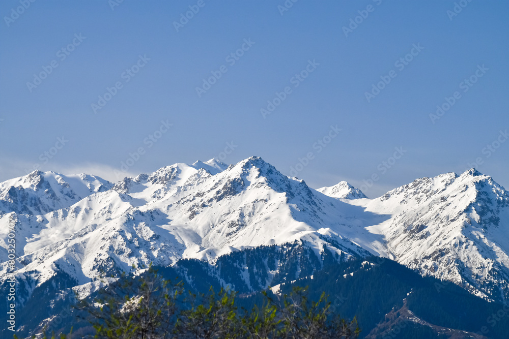 Snow covered mountains, Tian Shan, large system of mountain ranges in Central Asia Snow covered mountains, Tian Shan, large system of mountain ranges in Central Asia