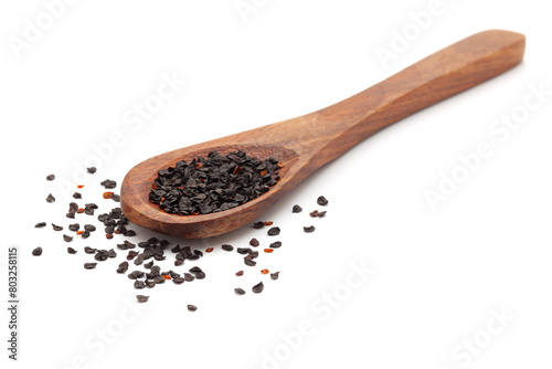 Front view of a wooden spoon filled with Organic Dianthus (Dianthus caryophyllus) seeds. Isolated on a white background.