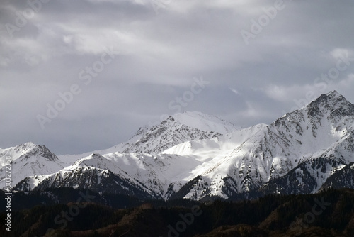 Snow covered mountains in cloudy weather, Tian Shan, large system of mountain ranges in Central Asia