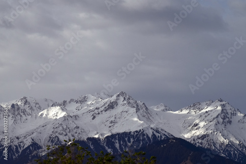 Snow covered mountains in cloudy weather, Tian Shan, large system of mountain ranges in Central Asia