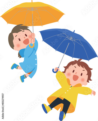 傘をさす雨具を身につけた子供たち