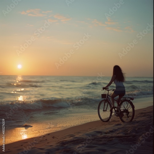 Summer sunset view of woman bike along the beach coast  © cristian