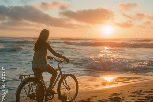 Summer sunset view of woman bike along the beach coast  © cff999