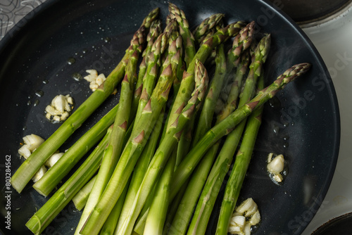 Asparagus fried with garlic in melted butter