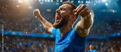 Ecstatic male soccer player celebrates a goal with his teammates in the stadium photo