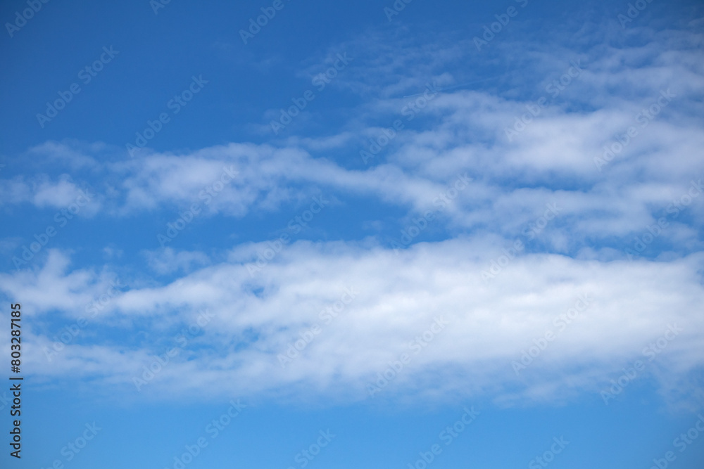 Natural pattern. Cloudy blue sky background. Calm sky and bright clouds in sunlight