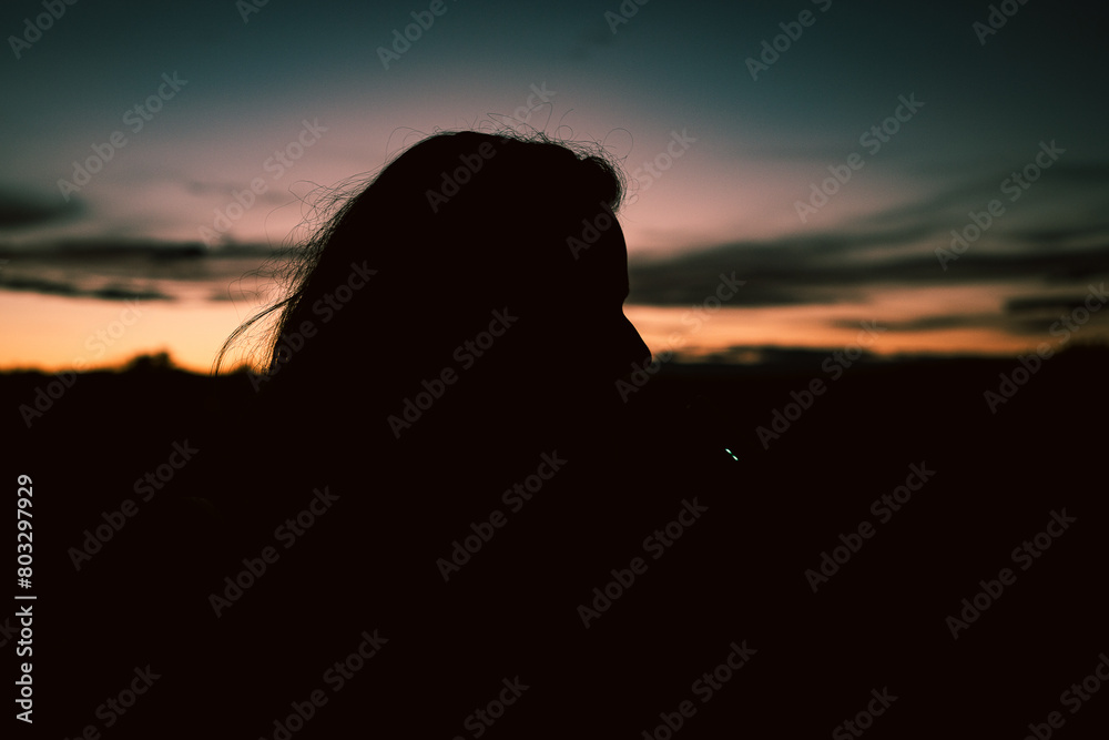 
Silhouette of a woman after sunset.