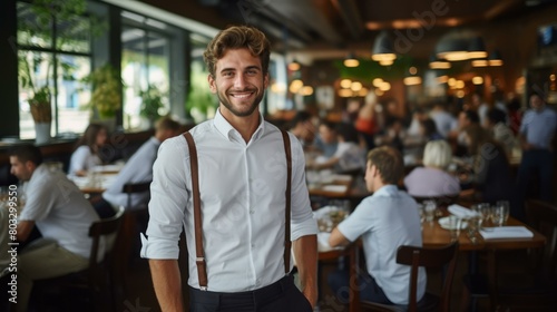 Handsome waiter in a busy restaurant