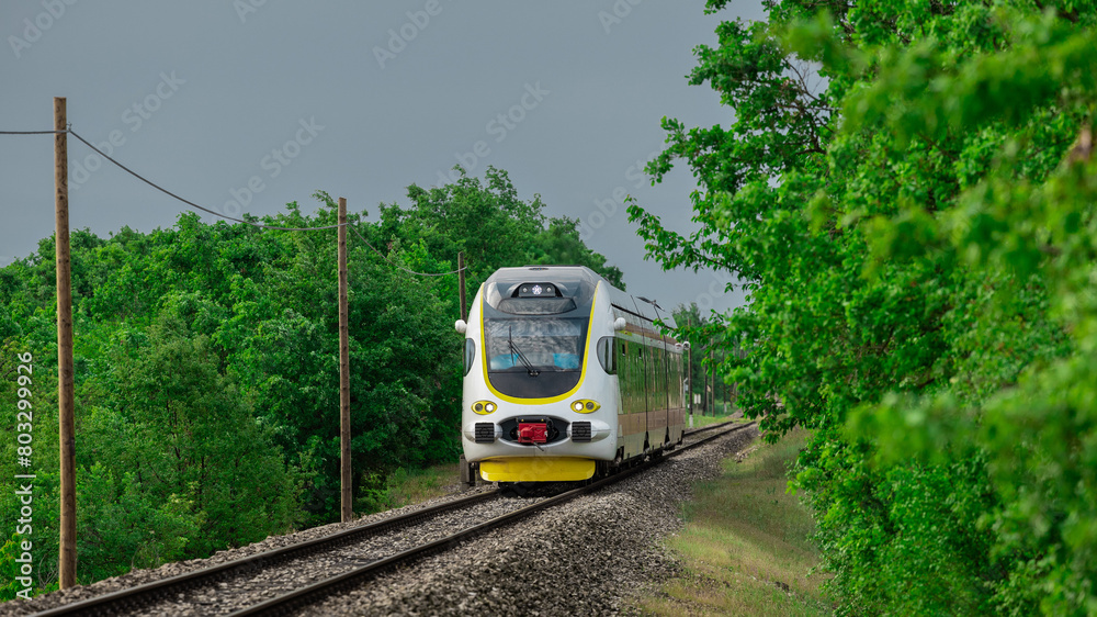 Naklejka premium Modern diesel-electric train set driving on the line between Buzet and Pula in croatian istria. Beautiful green scenery and white and yellow train. Train commute in istria