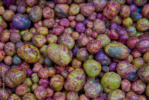 Close-up of many Olluco (Ullucus tuberosus), a tuber from the Andes mountains of South America. Known as melloco or papa lisa photo