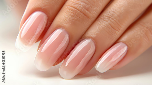 Beautiful nude manicure. Long nails. Delicate nude manicure close-up photo