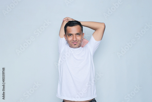 Fitness young asian man in sportswear warming up before jogging in the morning. Isolated on white background.
