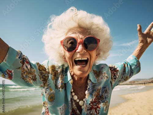 Beautiful elderly woman enjoying a joyful moment by the seashore