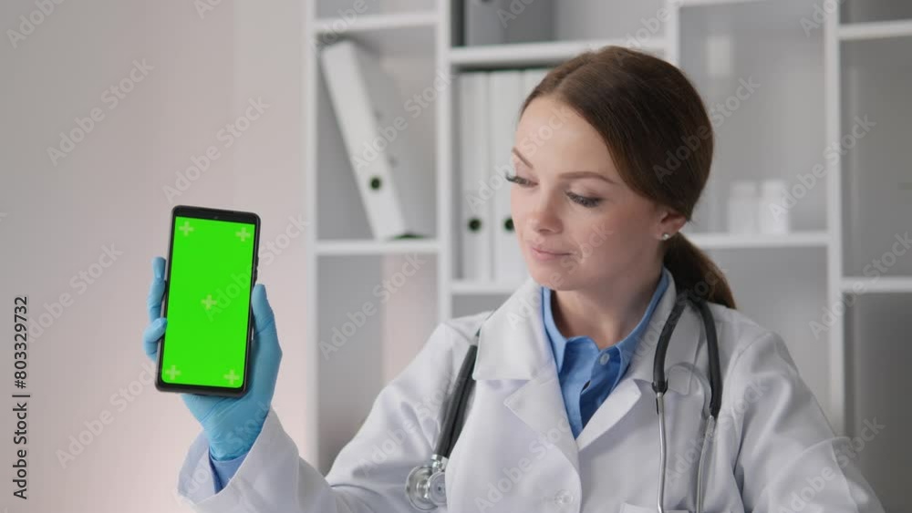 A cardiologist, holding his phone, conducts virtual consultations and reveals important aspects of heart health to patients through a smartphone screen. Phone Green Screen Chroma Key A cardiologist, holding his phone, conducts virtual consultations and reveals important aspects of heart health to patients through a smartphone screen. Phone Green Screen Chroma Key