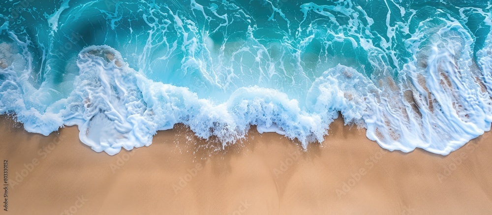 Fototapeta premium Wave on the sandy shore with room for text