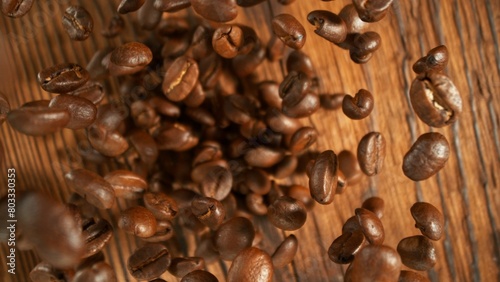 Freeze motion of flying coffee beans on old wooden planks