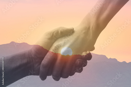 Person giving a helping hand on sunrise sky background. People help, relief and support concept